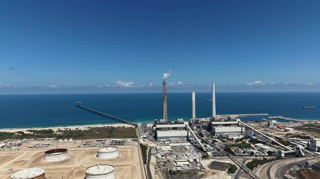 industrial smokestacks emitting plumes of smoke or steam into the atmosphere does climate change and energy	
