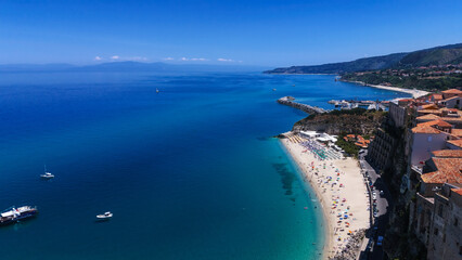 Obraz premium Aerial view of Tropea, a charming town perched on a cliff overlooking the beautiful turquoise waters of the Tyrrhenian Sea, Calabria, Southern Italy
