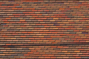 A brick wall with a red and brown color