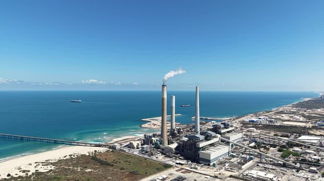 industrial smokestacks emitting plumes of smoke or steam into the atmosphere does climate change and energy	

