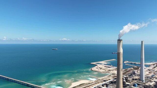 industrial smokestacks emitting plumes of smoke or steam into the atmosphere does climate change and energy	
