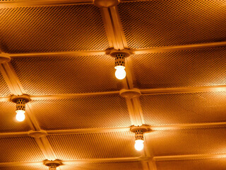 Decorative Ceiling Design with Warm Orange Lighting and Panel Strips