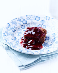 Chocolate brownie with cherry syrup . Selective focus. Copy space. 