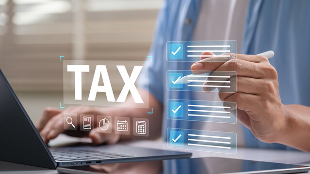 Digital tax filing and checklist concept showing a person using a stylus on a touchscreen laptop to manage financial documents, submit income returns, and prepare for tax season online efficiently