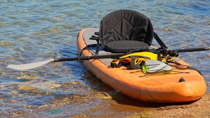 Inflatable board SUP, Stand Up Paddling surfboard for rowing. SUP prepared for watersport activities. Travelling water tourism at Lake Manitou, Manitoulin Island, Canada exploration.