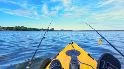 Kayaking on fishing pedal kayak at the lake during summer adventure, travel concept. PDL Drive fishing kayak with angler drifting during fishing at the lake. Fishing on kayak.