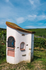 View of a wayside shrine with a statue of the Virgin Mary in the Johannisberg vineyards
