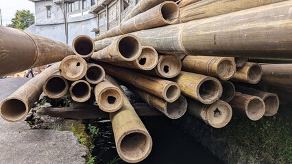 Stacked bamboo poles with natural texture and earthy colors, creating an organic