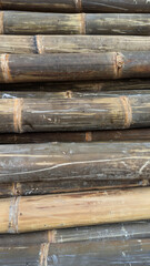 Stacked bamboo poles with natural texture and earthy colors, creating an organic