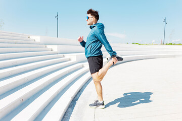 Engaging in a Refreshing Stretching Routine Amidst the Serene Beauty of a Contemporary Outdoor Park, All While Basking Under the Clear Blue Sky During the Midday Hours