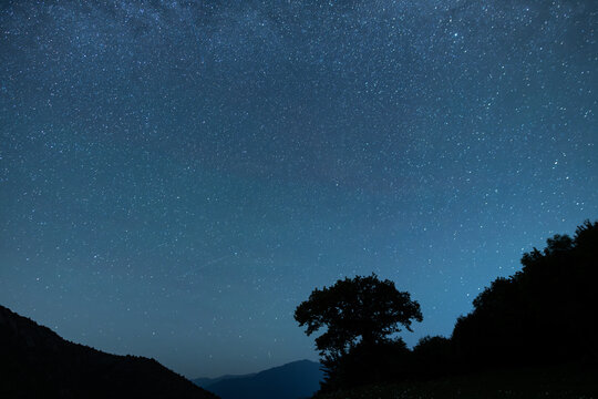 Beautiful night landscape, Bright Milky Way galaxy on the starry sky.,  over the trees and mountains.