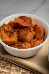 A southern side dish of yams at a family dinner, sweet and delicious seasoned with spices