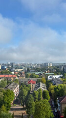 A wide-angle view from a high window overlooking the rooftops of Kaliningrad. The scene captures the mix of modern and historic architecture under a clear or cloudy sky