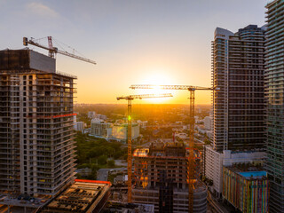 New construction site in Miami, Florida au sunset. Developing residence in American urban area. Concept of housing growth in the USA © bilanol