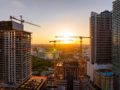 New construction site in Miami, Florida au sunset. Developing residence in American urban area. Concept of housing growth in the USA