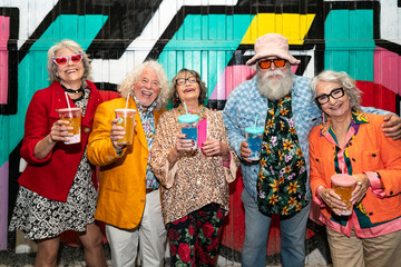 Group of happy senior friends with fancy clothing having party in the night