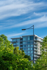 Modern apartment building with nice summer landscape in Vancouver, Canada, North America. Day time on June 2025.