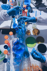 Scientist pipetting medical samples into microplate in laboratory