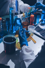 Scientist pipetting medical samples into microplate in laboratory