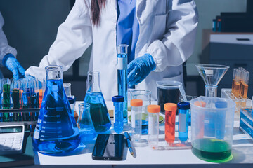 Scientist pipetting medical samples into microplate in laboratory