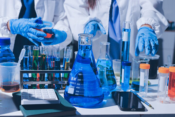 Scientist pipetting medical samples into microplate in laboratory