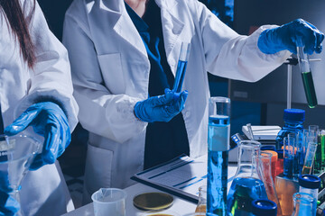 Scientist pipetting medical samples into microplate in laboratory