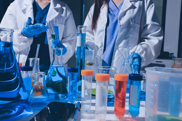 Scientist pipetting medical samples into microplate in laboratory