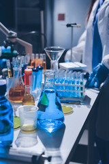 Scientist pipetting medical samples into microplate in laboratory