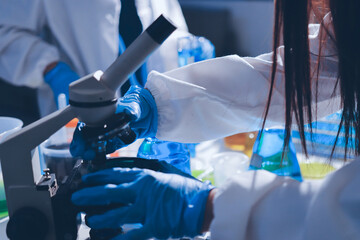 Scientist pipetting medical samples into microplate in laboratory