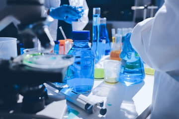 Scientist pipetting medical samples into microplate in laboratory