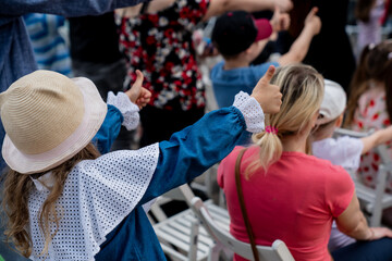Small children having fun activities and arms exercises in children's concert for active listening