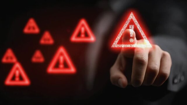 A person points at a glowing red warning icon with an exclamation mark, symbolizing caution or alert on a digital interface.