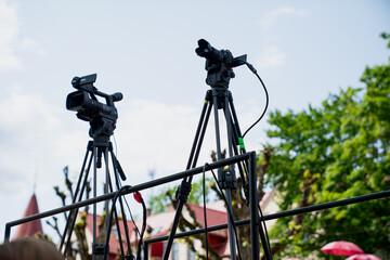 Technical camera setup for live recording, cameras set up on tripods during live event for...