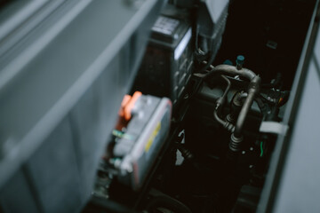 Car engine compartment showcasing various mechanical components in the vehicle's interior