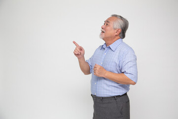 Senior Asian man pointing to empty copy space isolated on white background