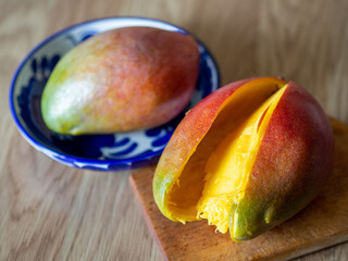 Ripe appetizing mango. Sweet and juicy mangoes on the table. Summer fruit concept