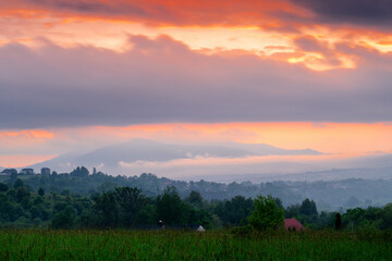 Sunset in the countryside with a view of the mountains, Beskids, Poland.	
