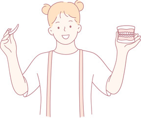 A cheerful girl holds a toothbrush with a dental model, promoting good dental hygiene habits for all