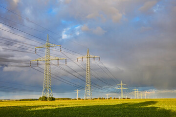 High-voltage power line in high-contrast evening light.