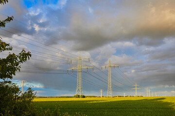 High-voltage power line in high-contrast evening light.