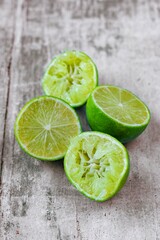 Lime halves on a wooden work surface.