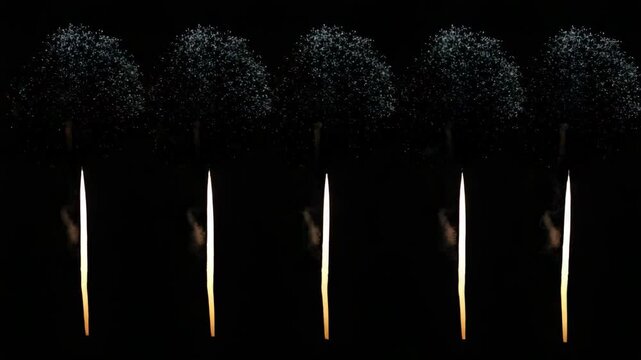 Matches igniting and burning in sequence against a black background  