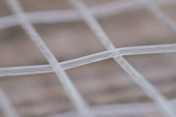 Extreme Close-up detail macro shot of a tennis racquet's strings. Sports Equipment. Ball Sport and Game concept. Depth of field.