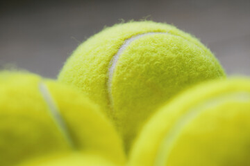 Extreme Close-up detail macro shot of tennis balls in dramatic lighting in Fluorescent, Optic yellow or Electric lime colour. Sports Equipment. Ball Sport and Game concept.