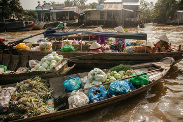 colorful bags for sale in boats at floating market in Vietnam