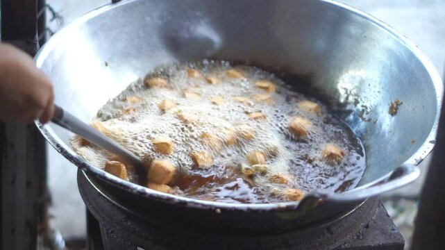 Sumedang tofu, fried in a frying pan using a gas stove