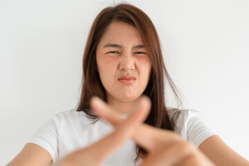 Fototapeta premium Asian woman making cross gesture with hands and serious face