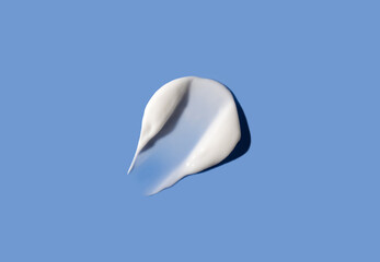 Cosmetic smear of cream texture on a blue background. Skin care.