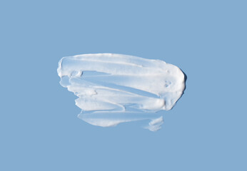Cosmetic smear of cream texture on a blue background. Large cream smear. Skin care.