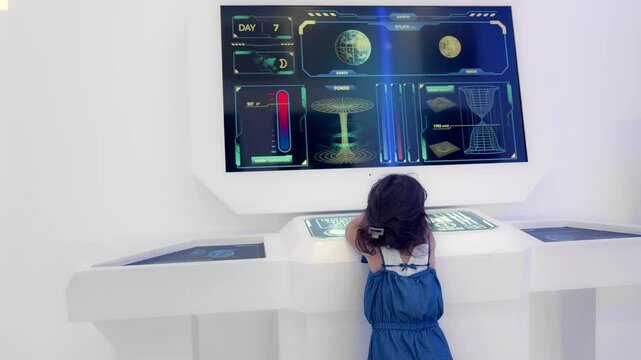 Young child explores a futuristic digital display in a Modern science museum, showcasing technology and curiosity.